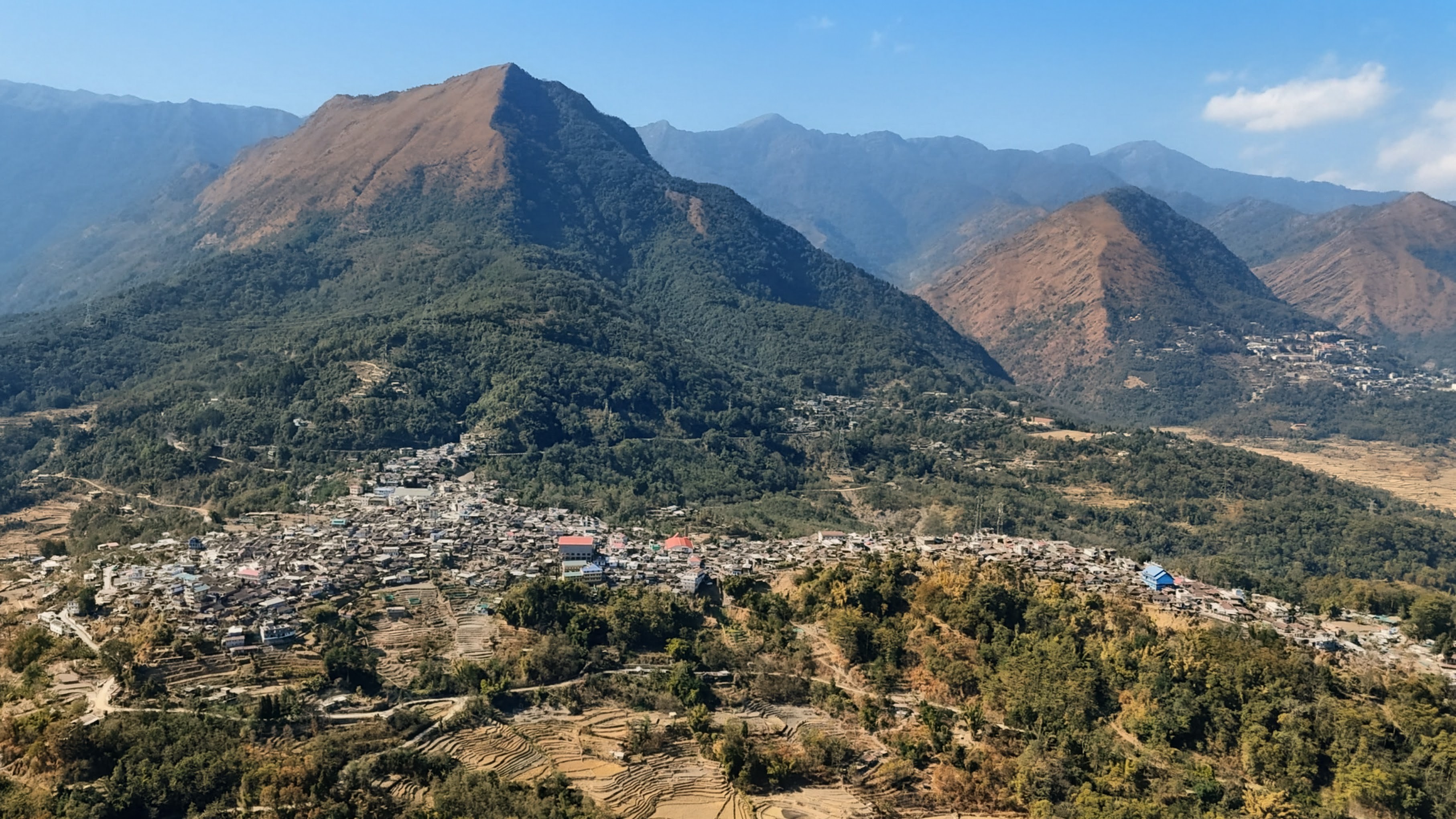 Viswema village stretching along the mountain ridge with terraced hills in the background